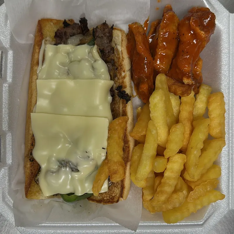 Philly cheesesteak with buffalo wings and fries